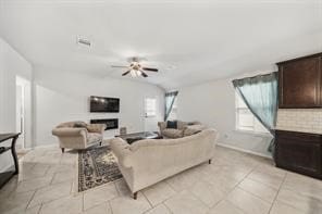 living room with light tile patterned floors and ceiling fan