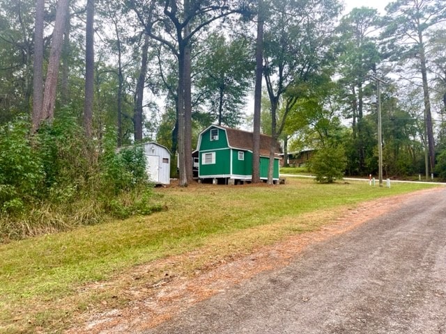 view of home's exterior with a shed and a yard