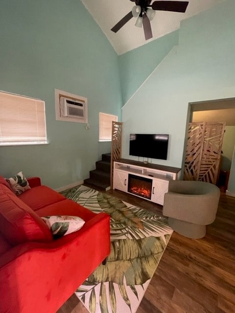 living room with hardwood / wood-style floors, a wealth of natural light, an AC wall unit, and high vaulted ceiling