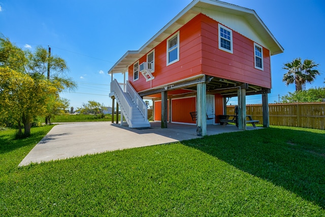 back of property featuring a patio, a lawn, and cooling unit