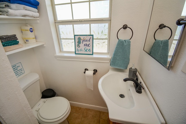 7120 E Hunter Dr, Hitchcock, TX 77563 - half bathroom with plenty of natural light, toilet, baseboards, and tile patterned floors