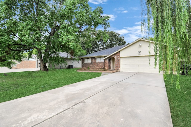 ranch-style house featuring a garage and a front lawn