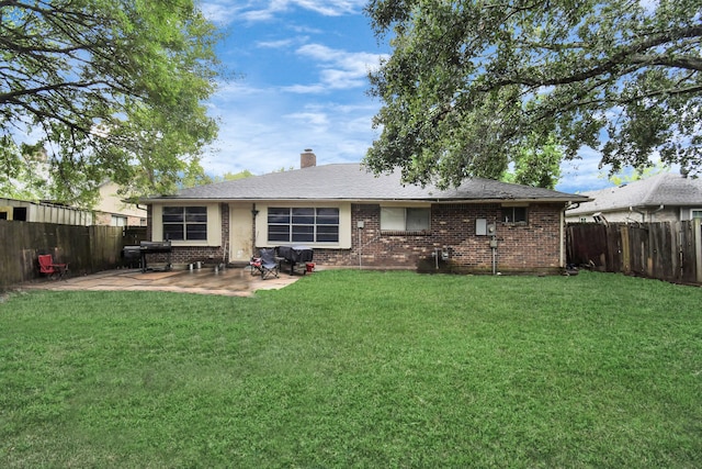 back of property featuring a patio and a lawn