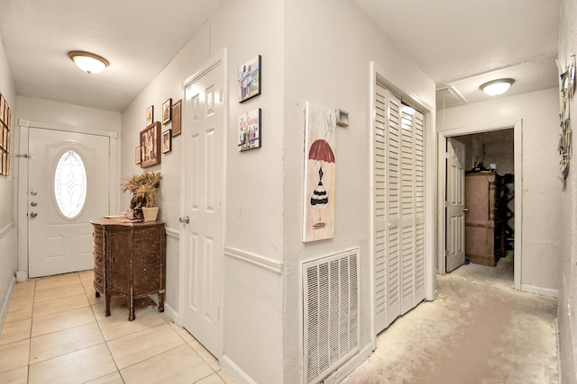 hall with light tile patterned floors