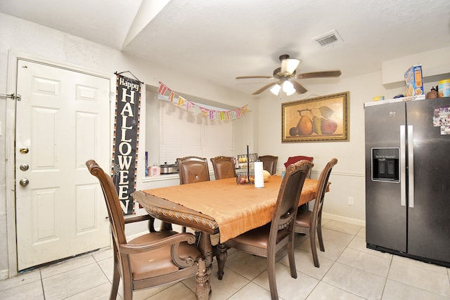 tiled dining area with ceiling fan