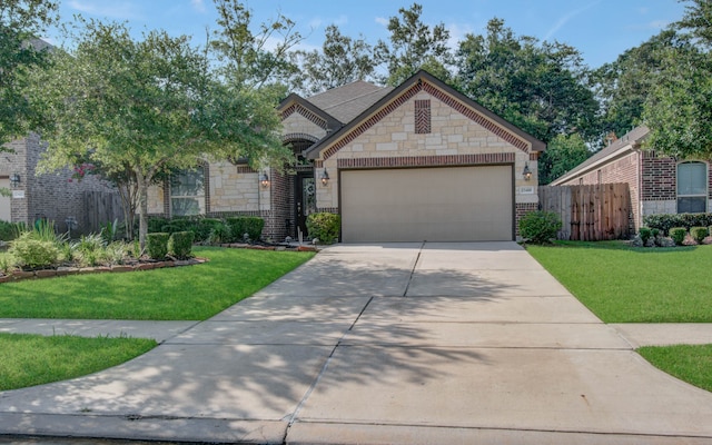 view of front of property featuring a front lawn and a garage