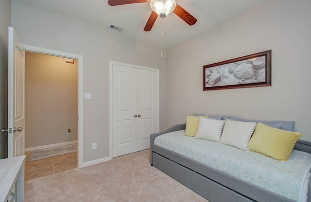 living room featuring ceiling fan and light colored carpet