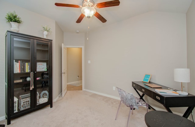 office space with ceiling fan, light colored carpet, and vaulted ceiling