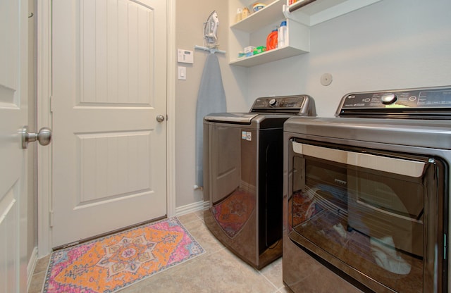 washroom featuring light tile patterned floors and washer and dryer