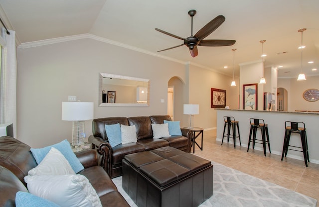 tiled living room featuring lofted ceiling, ceiling fan, and crown molding