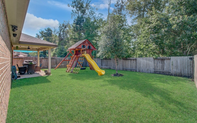 view of yard with a playground and a patio