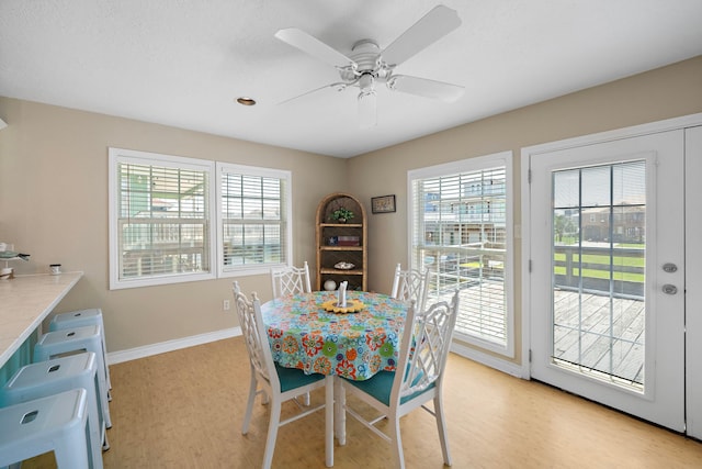 dining area featuring light hardwood / wood-style flooring, ceiling fan, and plenty of natural light