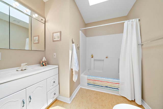 bathroom with shower / bath combo, wood-type flooring, a skylight, and vanity