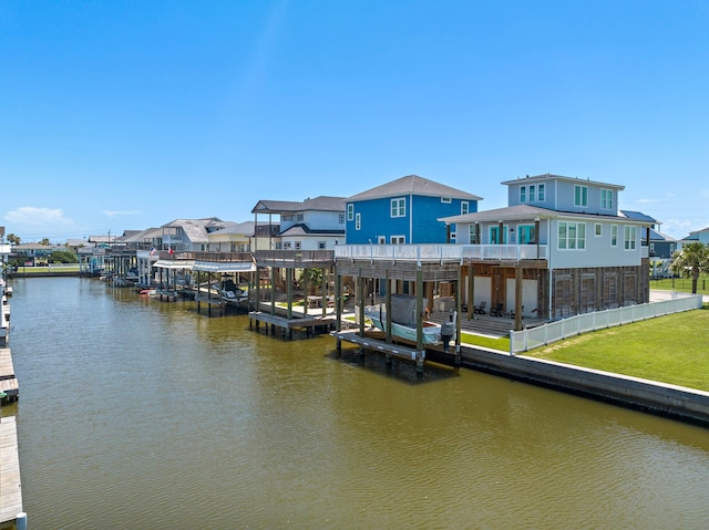 view of dock with a yard and a water view