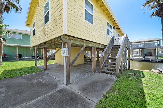 view of patio featuring a water view and a boat dock