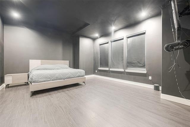 bedroom with hardwood / wood-style flooring