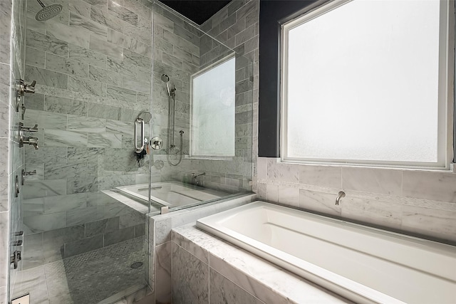 bathroom with plenty of natural light and plus walk in shower