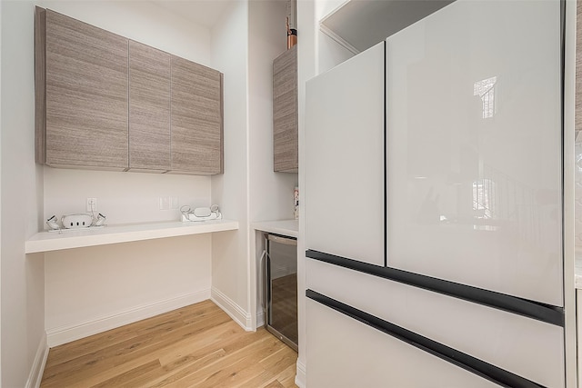 interior space featuring wine cooler and light hardwood / wood-style flooring