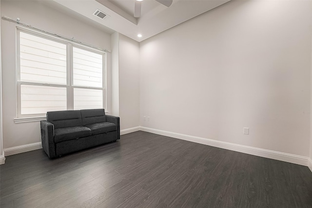 living area with dark hardwood / wood-style floors and ceiling fan