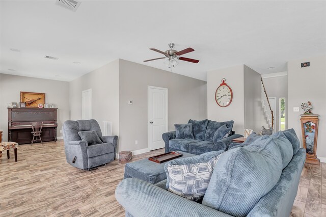 living room with light wood-type flooring and ceiling fan