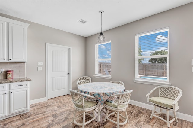 dining area featuring a wealth of natural light and light hardwood / wood-style flooring