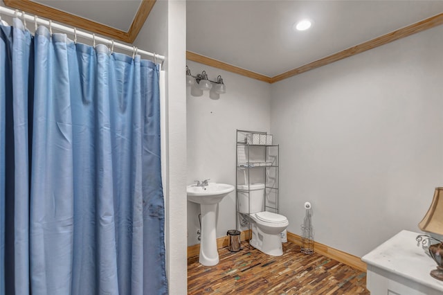 bathroom featuring toilet, hardwood / wood-style flooring, walk in shower, and crown molding