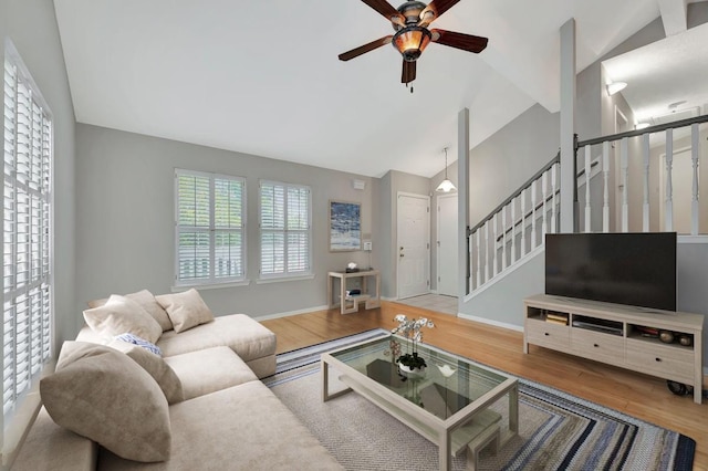 living room with ceiling fan, hardwood / wood-style floors, and lofted ceiling