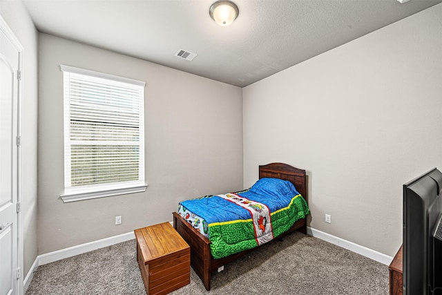 carpeted bedroom featuring baseboards