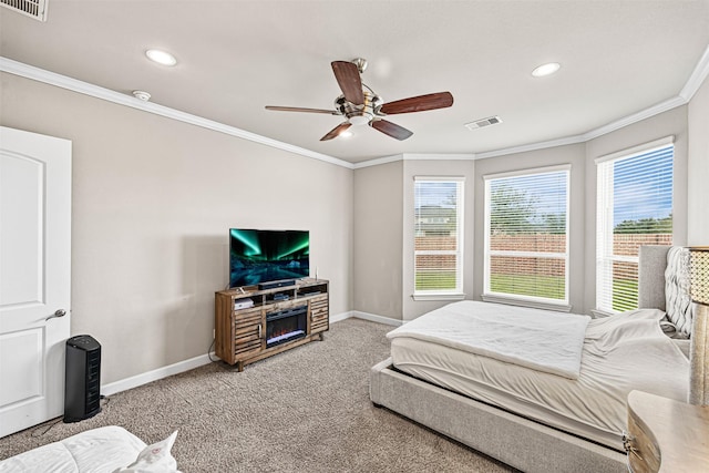 carpeted bedroom with baseboards, visible vents, and ornamental molding