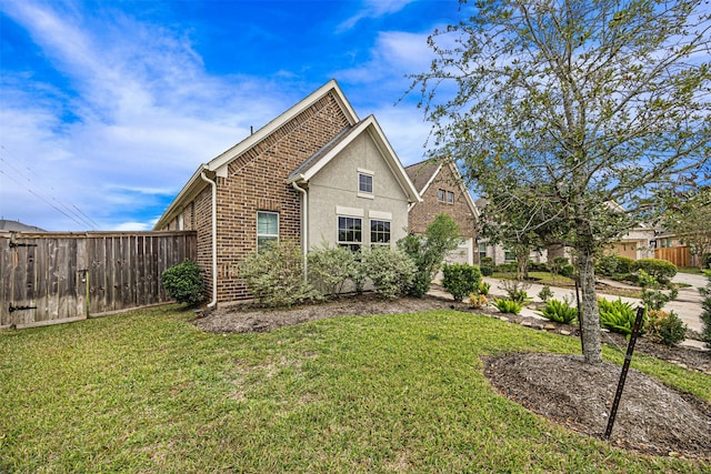 view of side of property featuring a yard