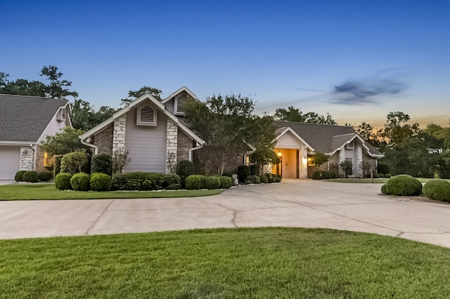 view of front of home with a lawn and a garage