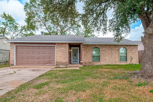 ranch-style home with a garage and a front lawn