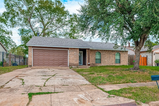 ranch-style home with a garage and a front yard