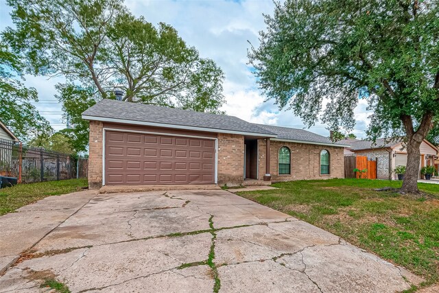 ranch-style house with a garage and a front yard