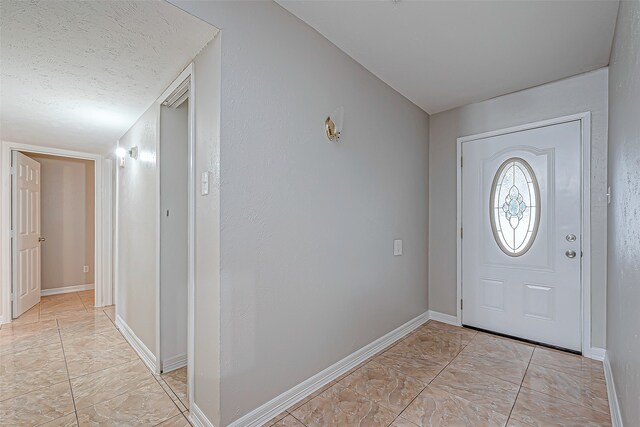 entryway with a textured ceiling