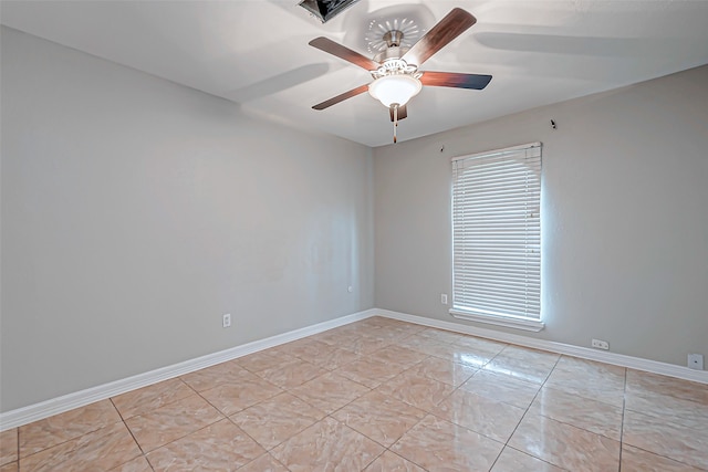 tiled empty room featuring ceiling fan