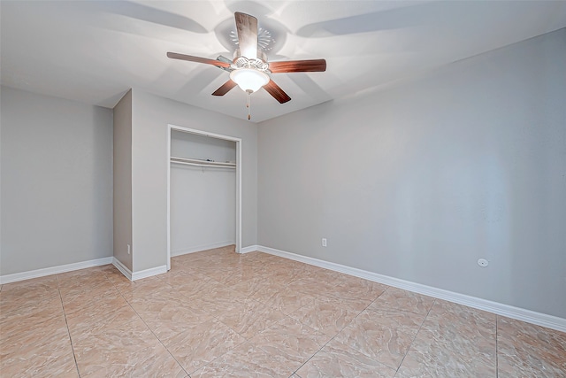 unfurnished bedroom featuring ceiling fan and a closet