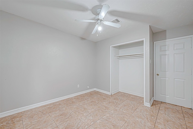 unfurnished bedroom featuring light tile patterned flooring, ceiling fan, and a closet