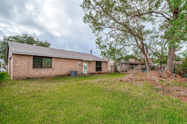 back of property featuring a yard and cooling unit