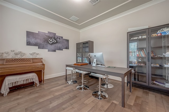 office area with wood-type flooring and ornamental molding