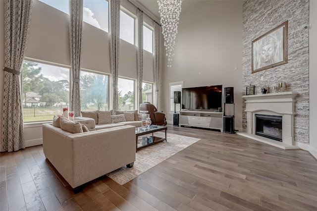 living room featuring a high ceiling, hardwood / wood-style floors, and a healthy amount of sunlight