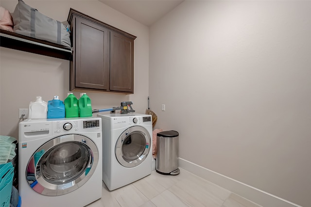 laundry area featuring cabinets and washing machine and dryer