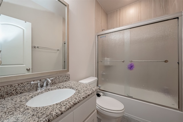 full bathroom with shower / bath combination with glass door, vanity, and toilet