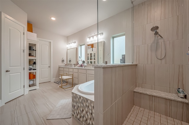 bathroom featuring independent shower and bath and vanity