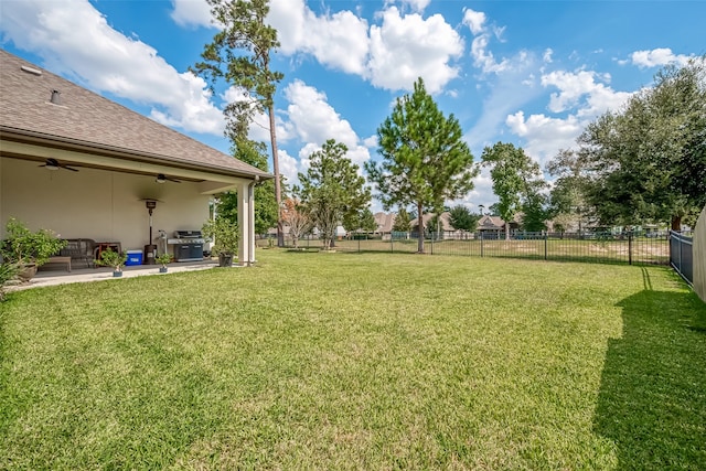 view of yard featuring a patio area and ceiling fan