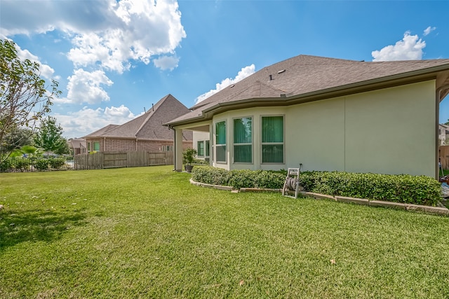 rear view of house with a lawn