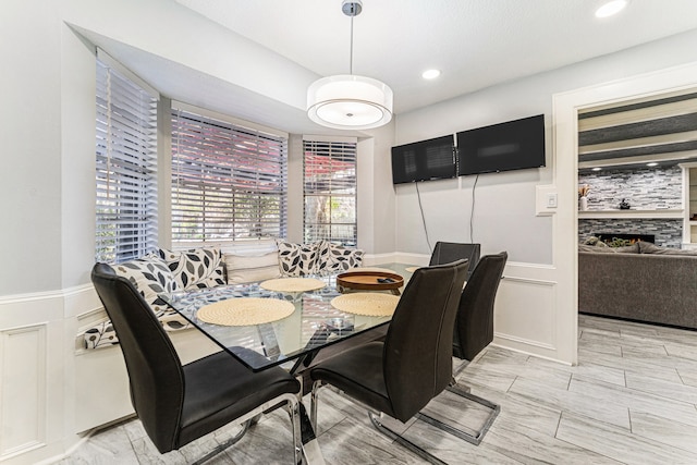 dining area with a tile fireplace