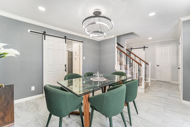 dining area with a textured ceiling, a barn door, and crown molding