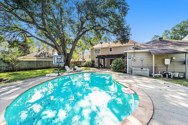 view of pool featuring a yard and a patio