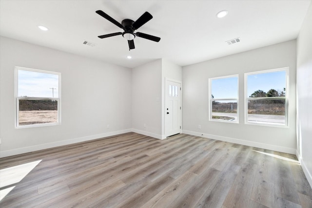 unfurnished living room with light hardwood / wood-style floors and ceiling fan